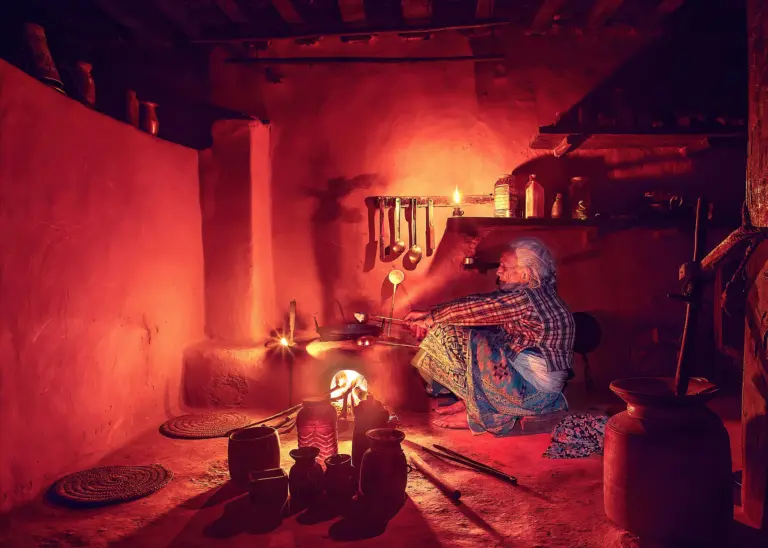 Grandmother preparing food inside traditional kitchen (edited)